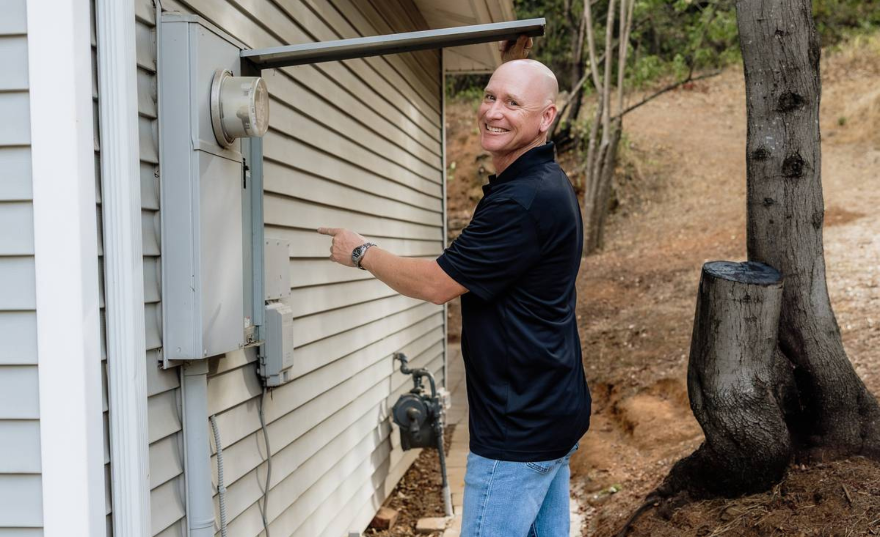 Nighthawk home inspector examining exterior electrical panel during a 1-year builder warranty inspection in Sacramento