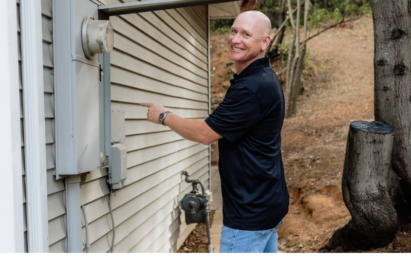 Home inspector examining exterior electrical components during a residential home inspection in Northern California.